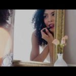 A Women doing lipstick on her lips