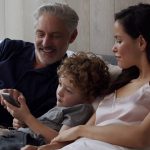 A child operate home automation system through his Dad's smartphone
