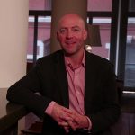 The man with smile seat on the chair